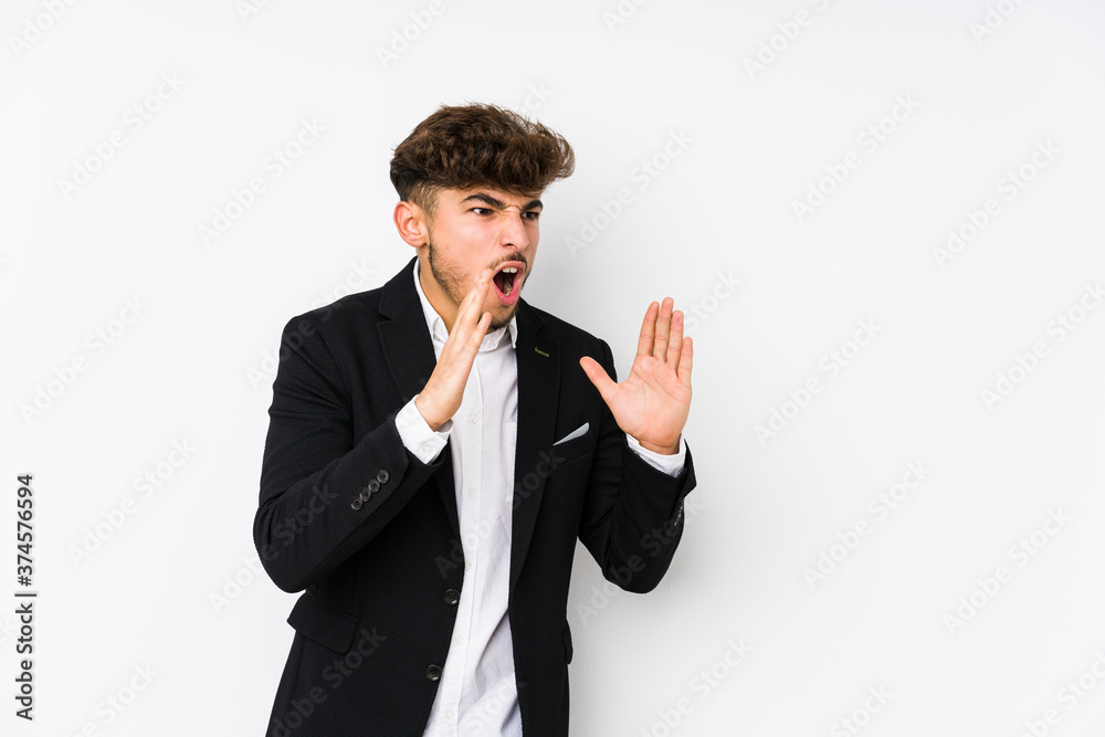 Young arabian business man isolated shouts loud, keeps eyes opened and hands tense. Young arabian business man isolated shouts loud, keeps eyes opened and hands tense.