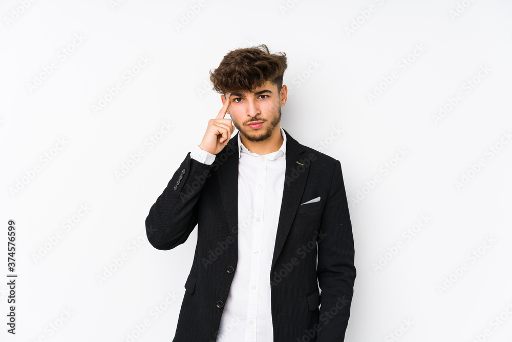 Young arabian business man isolated pointing temple with finger, thinking, focused on a task. Young arabian business man isolated pointing temple with finger, thinking, focused on a task.