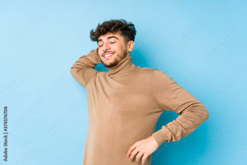 Young arabian man isolated stretching arms, relaxed position. Young arabian man isolated stretching arms, relaxed position.