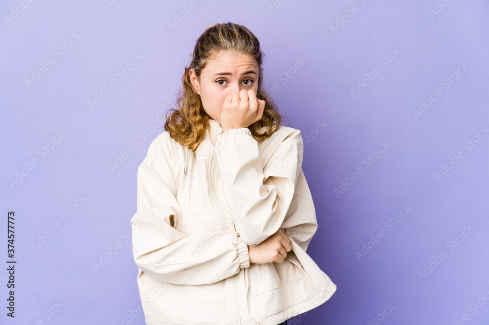 Young caucasian woman on purple background biting fingernails, nervous and very anxious. Young caucasian woman on purple background biting fingernails, nervous and very anxious.