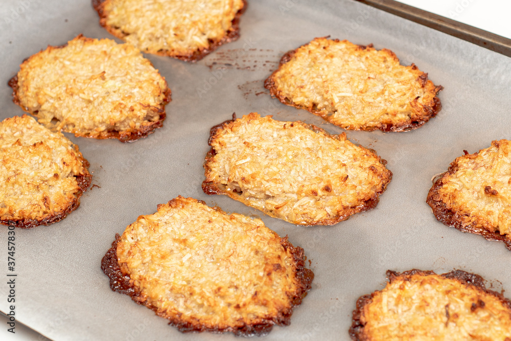Coconut and banana cookies preparation drizzled with melted chocolate. Baking