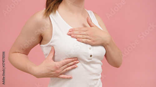 Wallpaper Mural Health and body care. Self examination of the breasts, breast cancer awareness concept. Isolated on pink background. High quality photo Torontodigital.ca