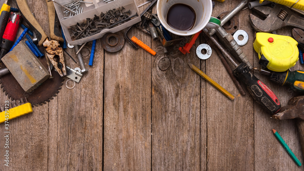 A set of old tools and a Cup of coffee on an old wooden table. A set of old tools and a Cup of coffee on an old wooden table.