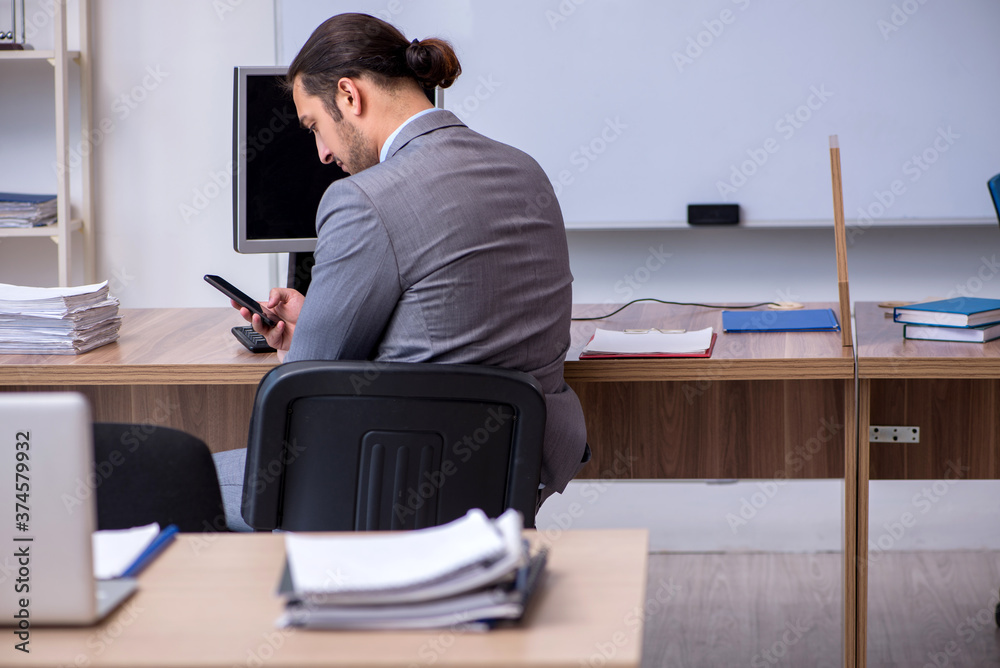 Young male businessman employee working in the office Young male businessman employee working in the office