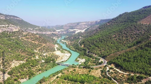 A canyon or gorge is a deep cleft between escarpments or cliffs resulting from weathering and the erosive activity of a river over geologic time scales. photo