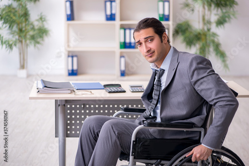 Young male employee in wheel-chair
