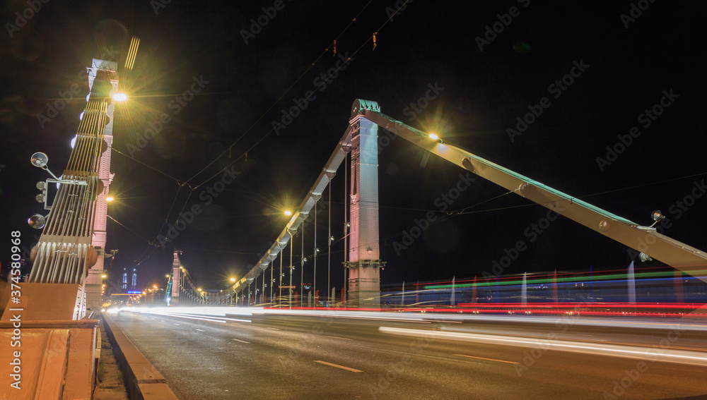 Obraz premium Krymsky bridge in Moscow, Russia. Evening. Car traces