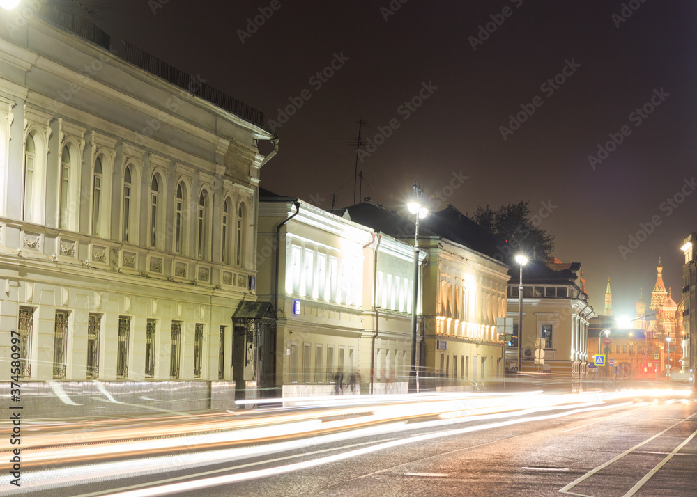 Moscow, Russia. Ordynka street in evening. Car traces. St. Basil's cathedral in background.