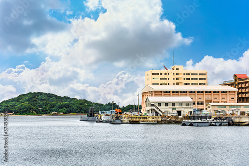 yokosuka, japan - july 19 2020: Wide angle view of the japanese submarine Takashio berthed in front of the japan maritime self-defense force Second Diving Group Command in the Yokosuka naval port. photo
