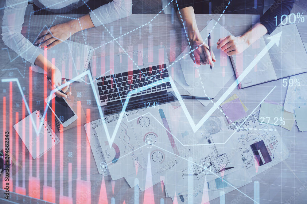 Double exposure of woman hands working on computer and forex graph hologram drawing. Top View. Financial analysis concept. Double exposure of woman hands working on computer and forex graph hologram drawing. Top View. Financial analysis concept.