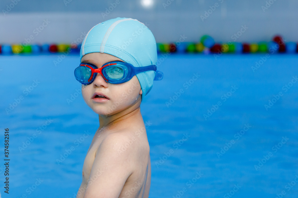 professional young swimmer in blue cap ready to swims in pool wather