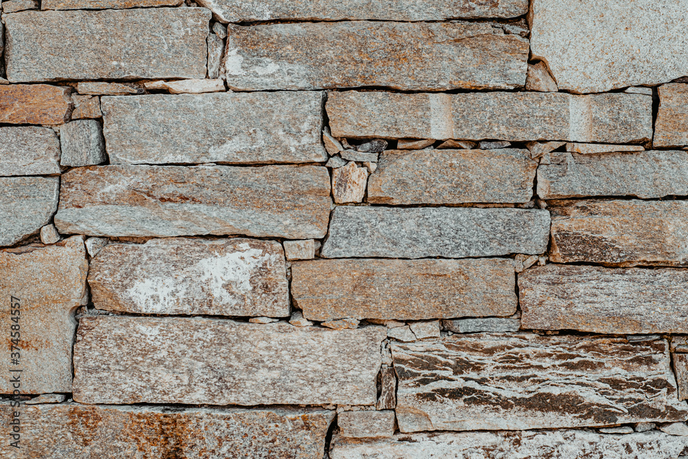 Fototapeta premium Light beige stone wall tiles. Wall texture and pattern.