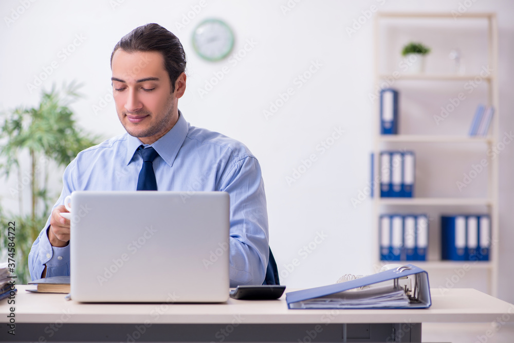 Young male employee in the office Young male employee in the office