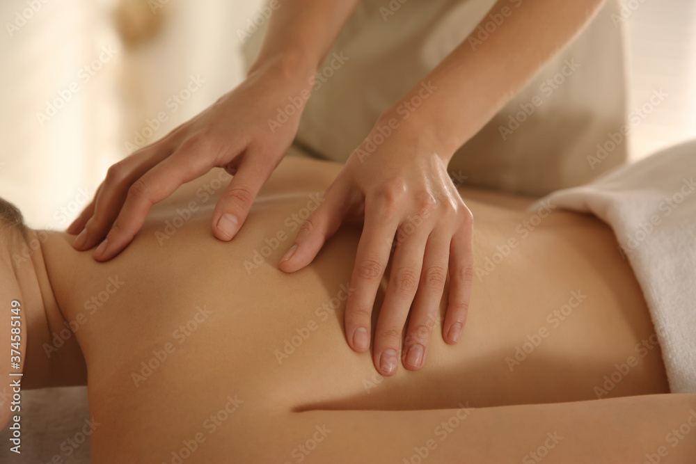 Young woman receiving back massage in spa salon, closeup Young woman receiving back massage in spa salon, closeup