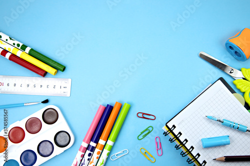 school items on a blue background. stationery