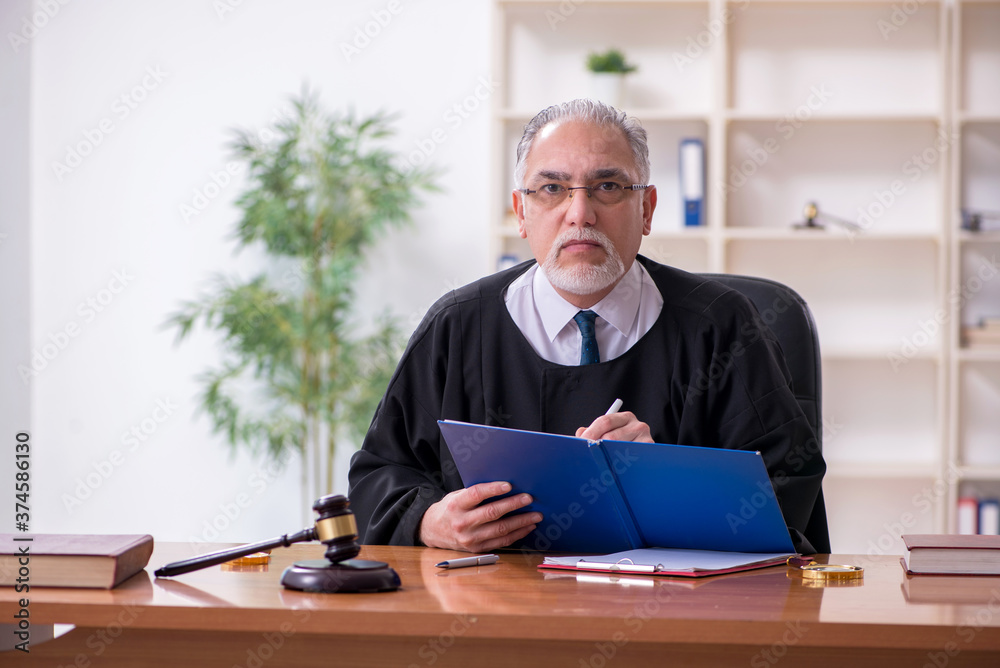 Old male judge working in courthouse Old male judge working in courthouse