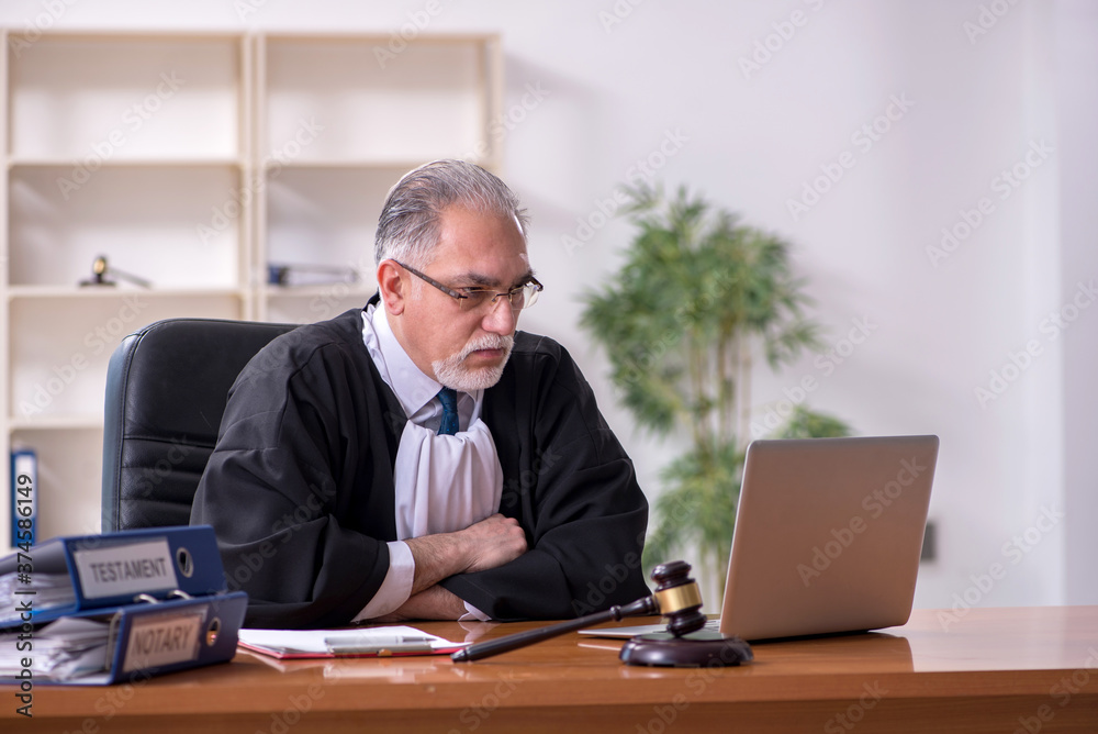 Old male judge working in courthouse Old male judge working in courthouse