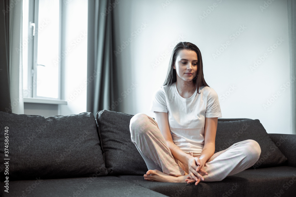Young woman pretty relaxing on couch in living room Young woman pretty relaxing on couch in living room