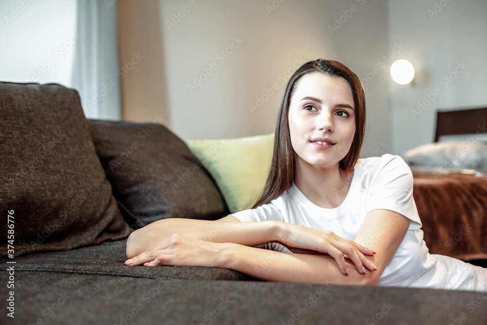 Young woman pretty relaxing on couch in living room Young woman pretty relaxing on couch in living room