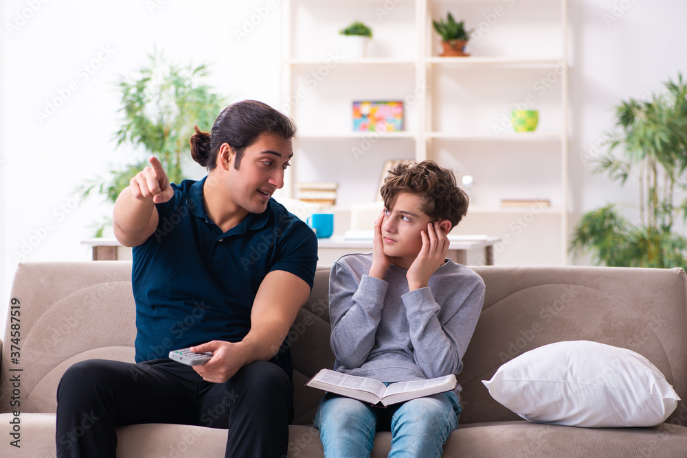 Father and son in exam preparation concept Father and son in exam preparation concept