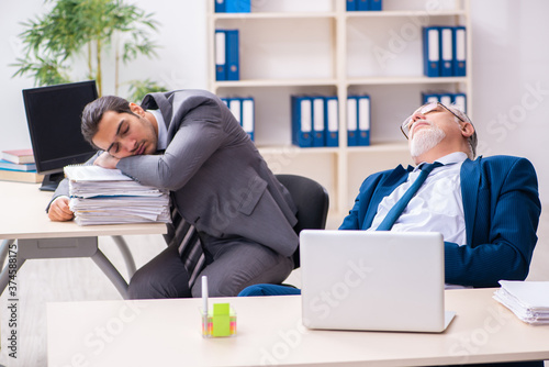 Two male employees working in the office