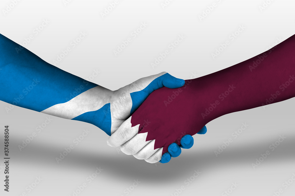 Handshake between qatar and scotland flags painted on hands, illustration with clipping path. Handshake between qatar and scotland flags painted on hands, illustration with clipping path.