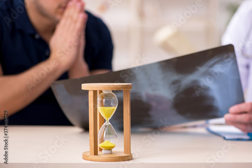 Male patient visiting doctor radiologist in time management conc