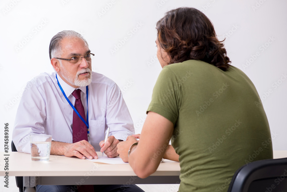 Young man meeting with advocate in pre-trial detention