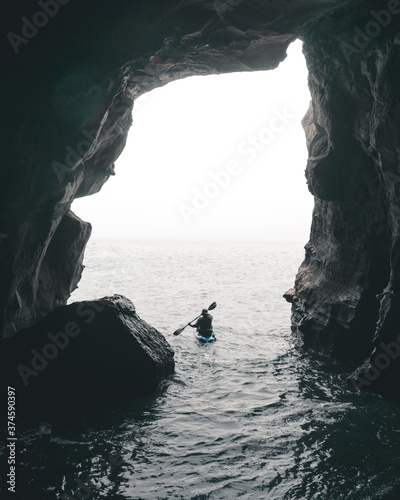 Kayaker in sea cave