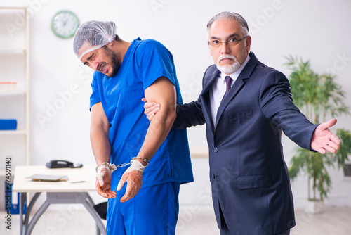 Male doctor in courthouse meeting with advocate