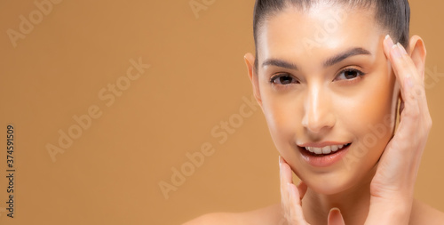 Beautiful woman with healthy skin with a brown background. Take care of your skin by spa course. Smile face