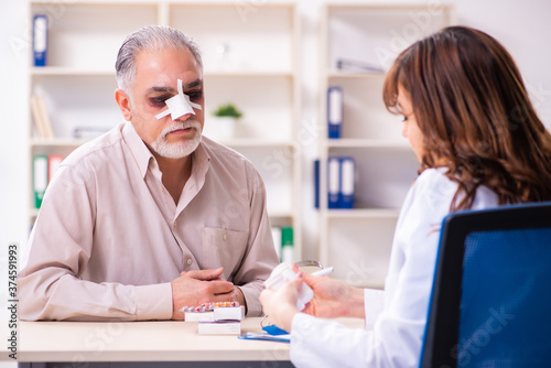 Old man visiting young female doctor for plastic surgery