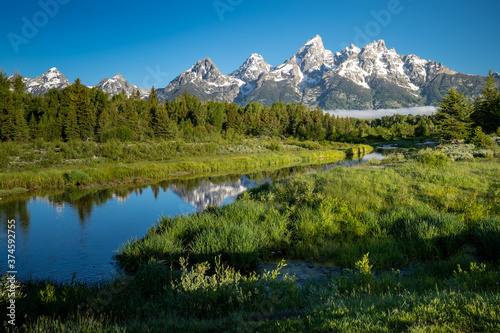  Schwabachers Landing in the early morning in Grand Teton National Park, with mountain reflections on the water creek