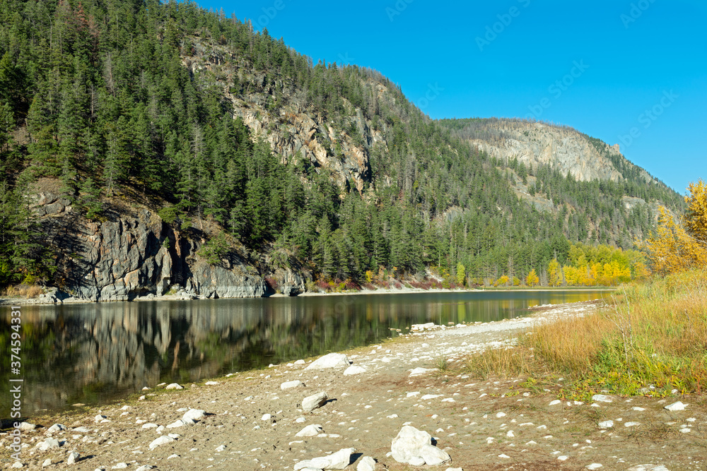 Fototapeta premium Rocky cliffs and mountains along the shore of Crown Lake in Marble Canyon Provincial Park, British Columbia, Canada