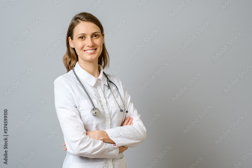 Smiling female doctor in lab coat with arms crossed Smiling female doctor in lab coat with arms crossed