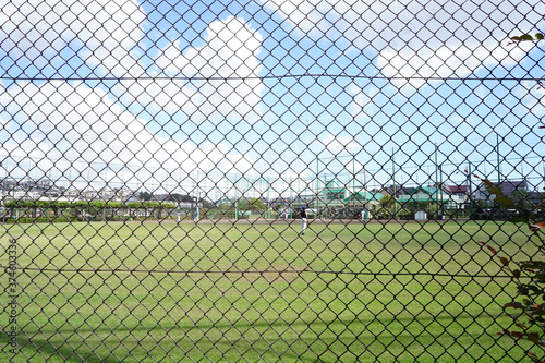 fence os baseball field in a summer day