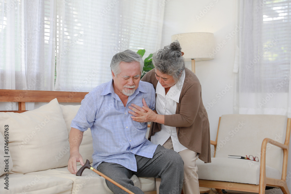 Obraz premium middle aged Asia man feeling pain ache touching chest having heart attack, sad worried senior older lady suffers from heartache at home, infarction or female heart disease concept