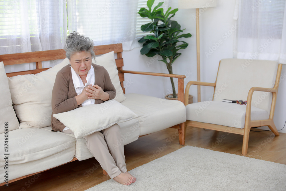 middle aged Asia woman feeling pain ache touching chest having heart attack, sad worried senior older lady suffers from heartache at home, infarction or female heart disease concept middle aged Asia woman feeling pain ache touching chest having heart attack, sad worried senior older lady suffers from heartache at home, infarction or female heart disease concept