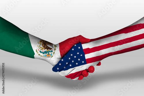 Handshake between united states of america and mexico flags painted on hands, illustration with clipping path. photo