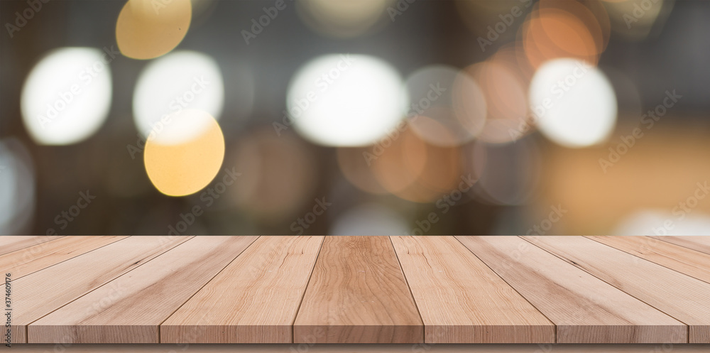 Empty wooden table top with lights bokeh on blur restaurant background Empty wooden table top with lights bokeh on blur restaurant background