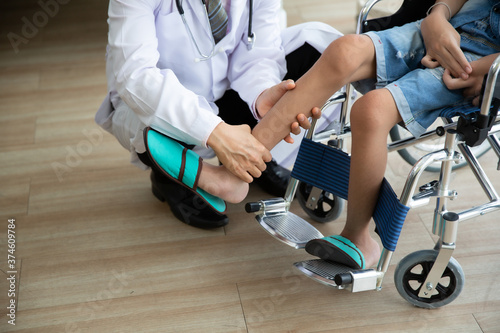 Doctor checking disabled person pateint leg at hospital, Muscle weakness photo