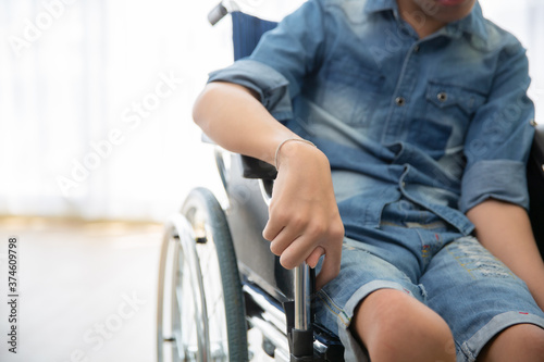 Disabled person sitting on wheelchair photo