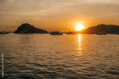 parking of ships.city port.Wild islands of Indonesia. Flores tropical paradise. Labuan Bajo. drone shooting. Wild beaches, blue logons, coral reefs, green hills. aerial view. boat trip safari. harbor 