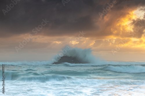 Waves crashing over rock