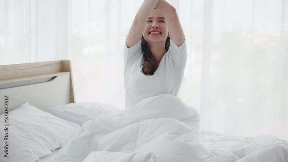 Beautiful Asian woman wake up in morning feeling refresh and happy. Adequate sleep help keep you Good healthy. Clean bedroom no from bacteria and disease. Concept Health care