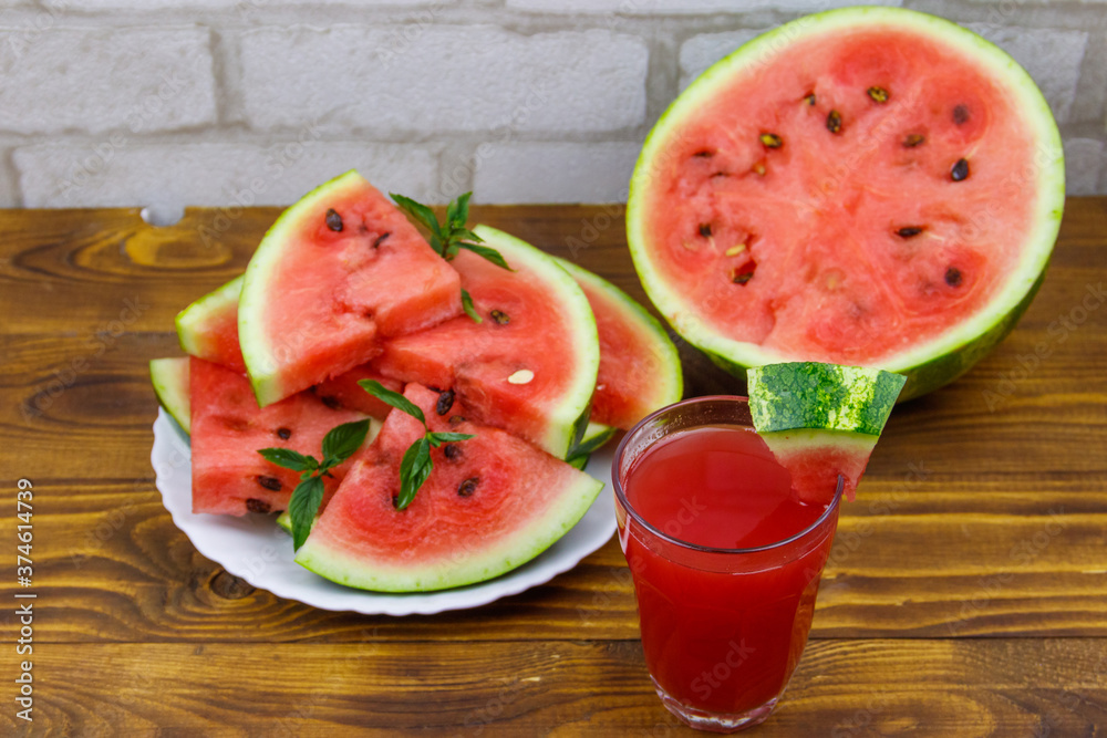 Glass of fresh watermelon juice on a wooden table Glass of fresh watermelon juice on a wooden table