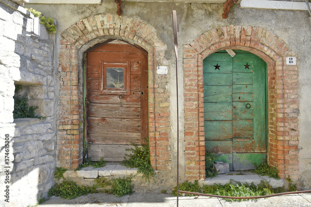 Fototapeta premium Old wooden doors of an abandoned house in Cercemaggiore, a rural village in the Molise region, Italy.