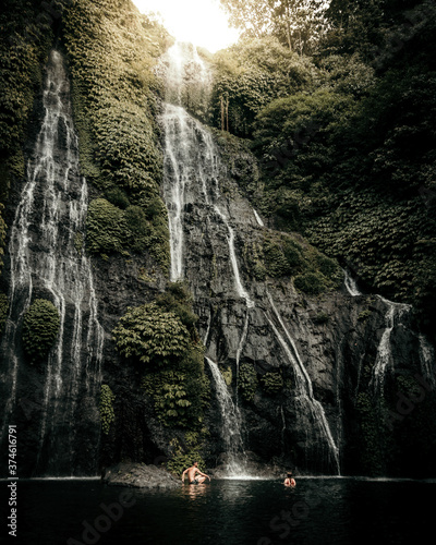 Two models in a beautiful waterfall in Bali Indonesia