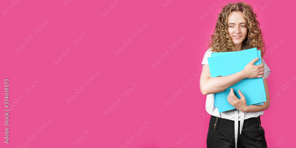 A young woman holds folders with documents in her hands. A young woman holds folders with documents in her hands.