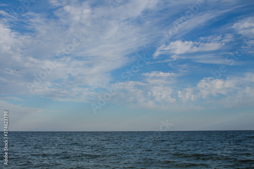 sea water with blue bowls and clouds